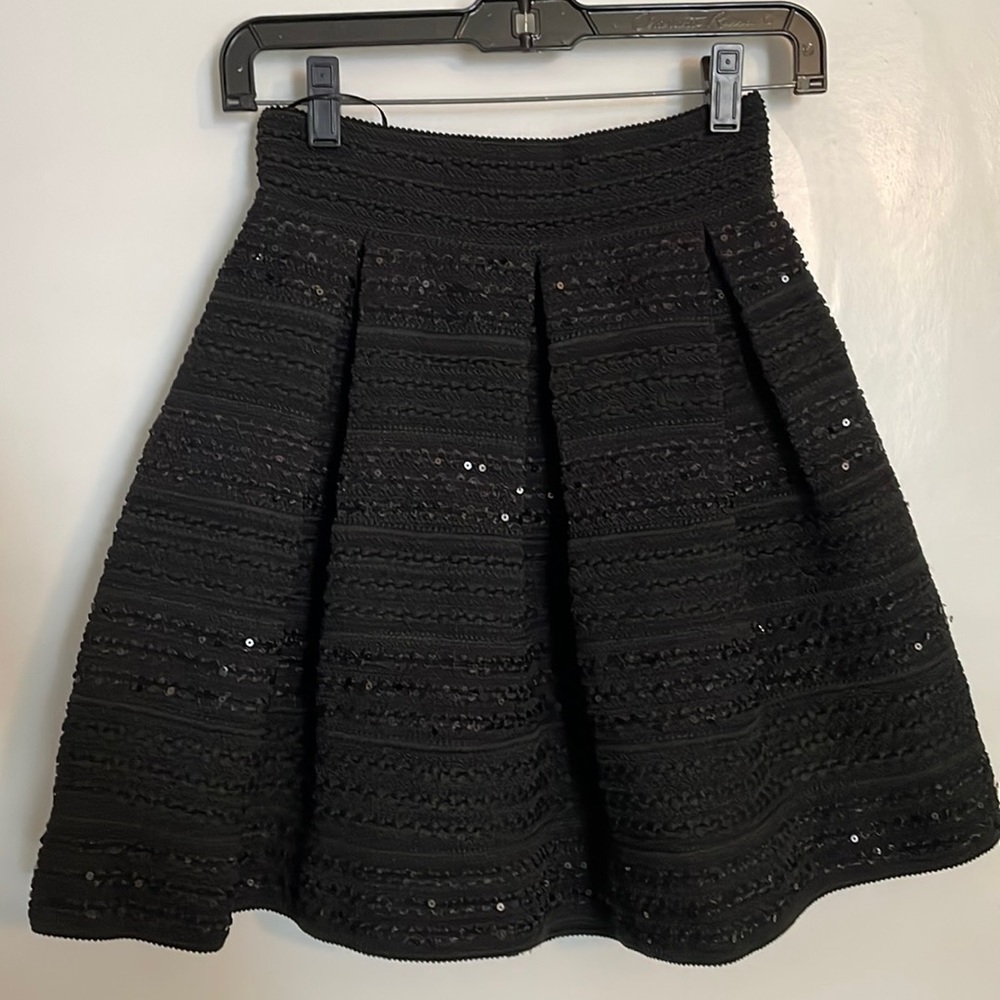Black structured peplum skirt with black sequin detail.